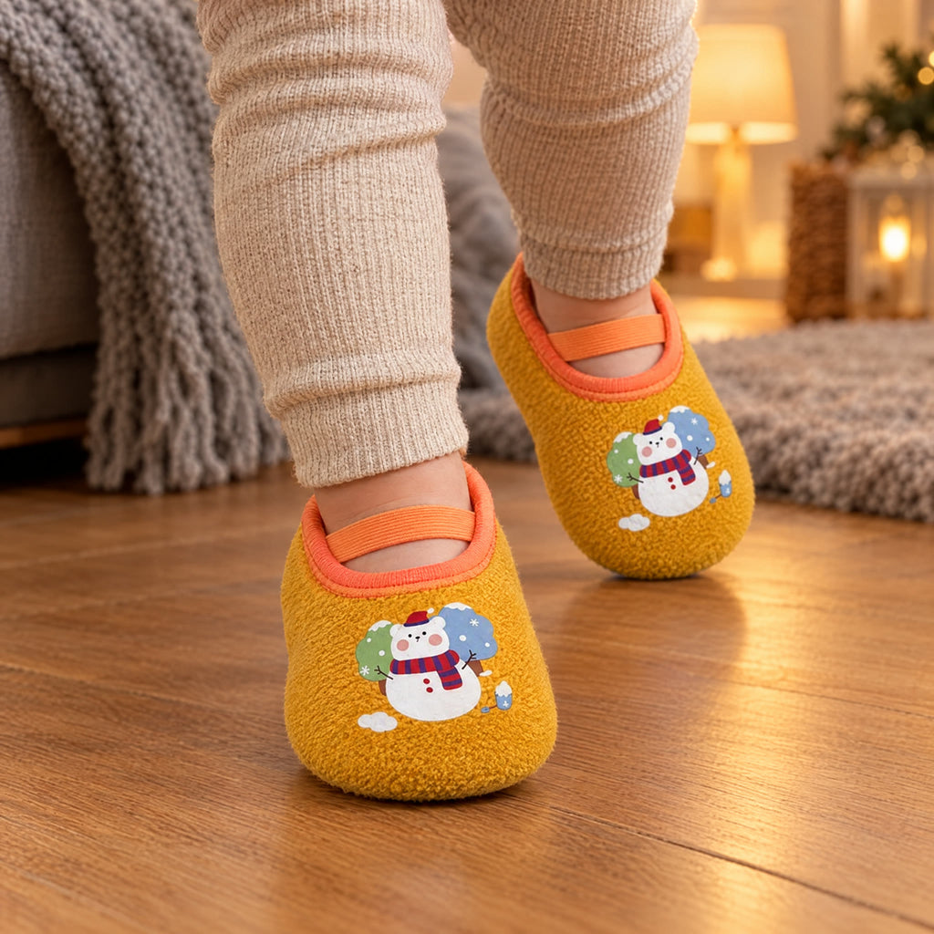 Snow Bear – a toddler walking on a wooden floor in Snow Bear grip socks