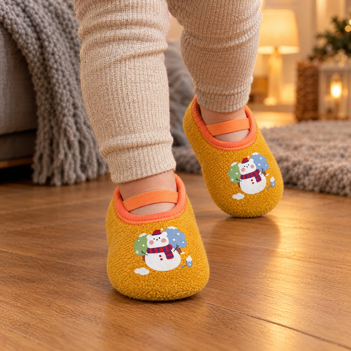 Snow Bear – a toddler walking on a wooden floor in Snow Bear grip socks