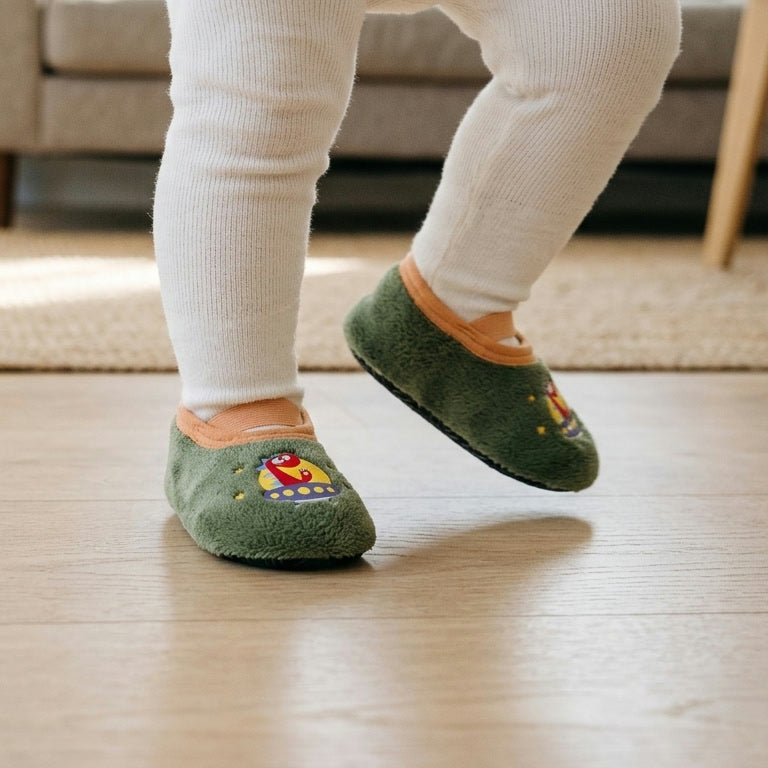 Space Dino – a toddler taking a step on a wooden floor