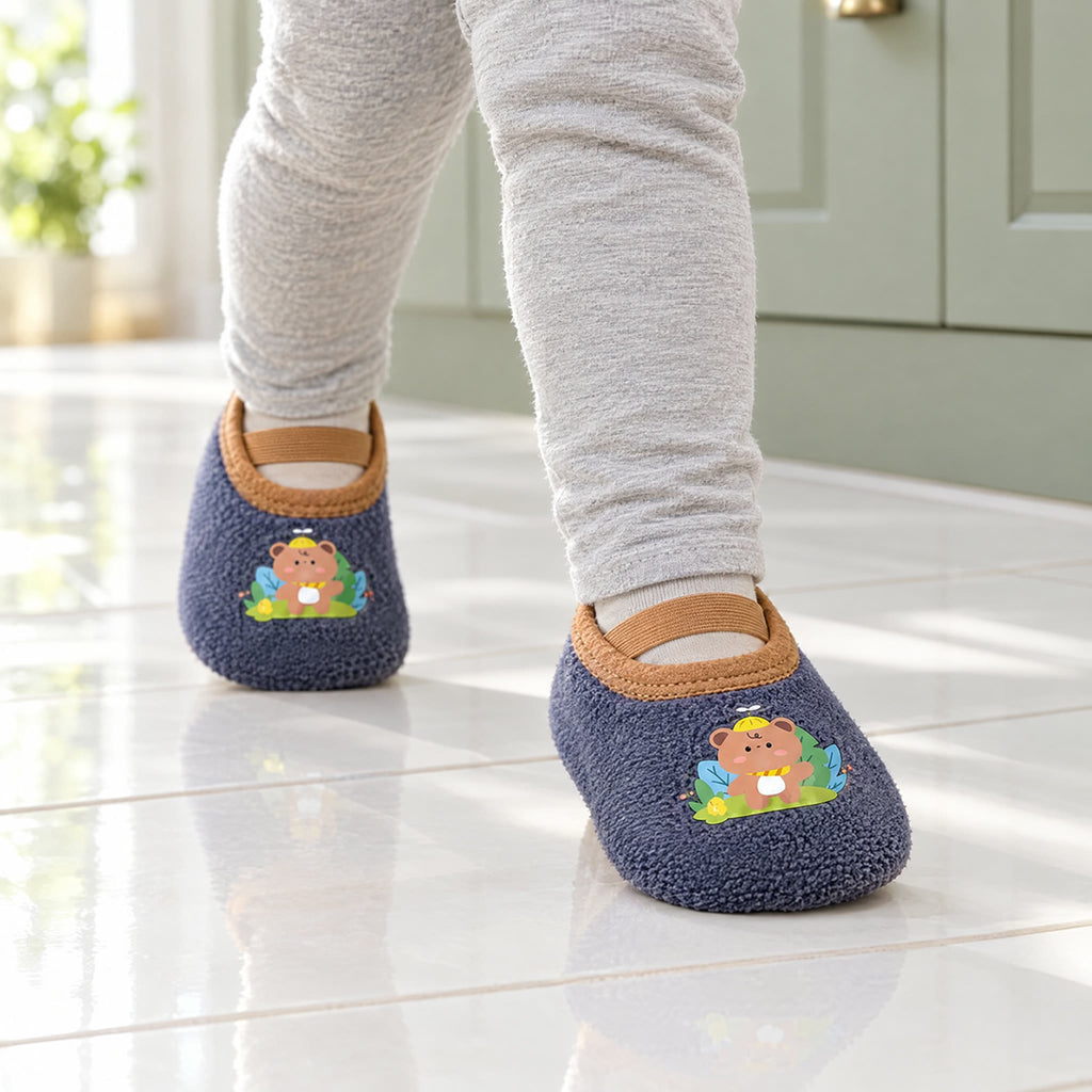 Teddy Bear – a toddler walking across kitchen tiles in Teddy Bear grip socks